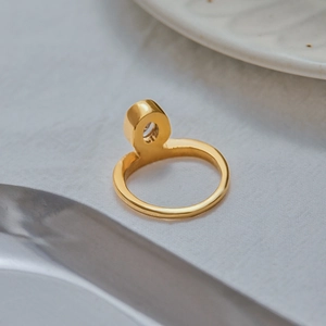 Macro shot of 18K gold plated titanium ring featuring a brilliant round-cut cubic zirconia
