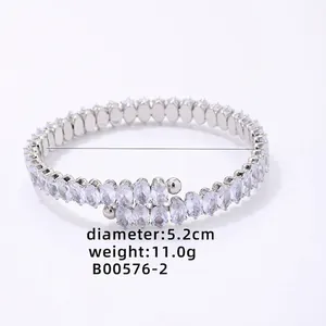 Detail view of oval cut cubic zirconia stones on silver bypass bracelet with 5.2cm diameter