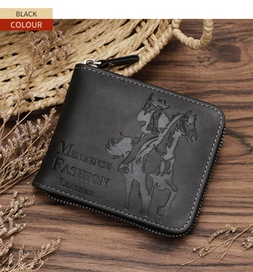 Close-up of black retro leather wallet with horse rider embossing on wood surface
