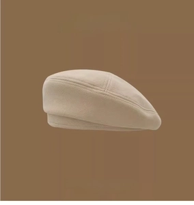 Close-up of beige wool beret featuring a vintage minimalist design for autumn winter