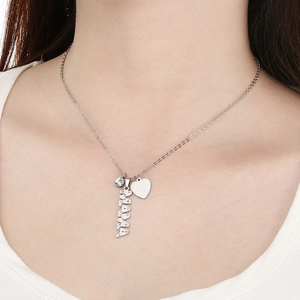 Detail of silver MAMA letter necklace with rhinestone heart pendant on female model