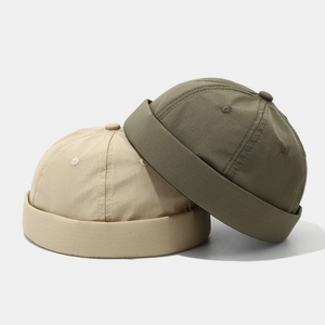 Minimalist quick-dry brimless docker hats in beige and army green with rolled edge
