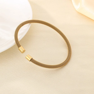 Detailed macro shot of 4mm 18K gold plated mesh cable weave texture on stainless steel cuff
