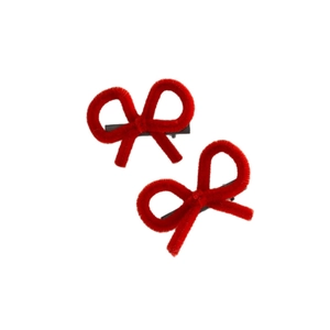 Pair of red plush bow hair clips with black metal duckbill clips on white background
