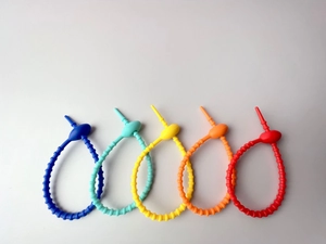 Flat lay of colorful adjustable silicone strap ring chains in five bright matte shades