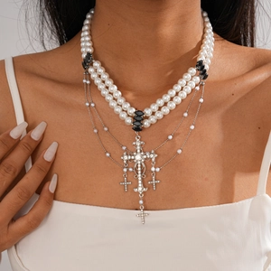 Close-up of double-layer faux pearl sweater chain with rhinestone cross pendants