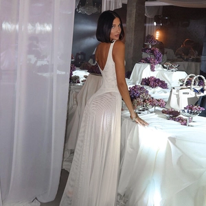 Detailed view of white mesh evening gown featuring deep V back and elegant A-line silhouette