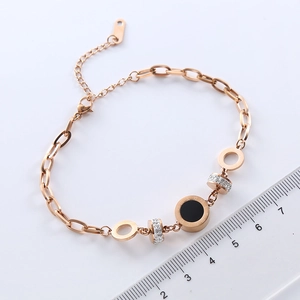 Rose gold stainless steel bracelet with Roman numeral disc and diamond-encrusted beads