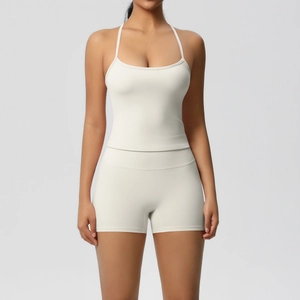 Detail of cream-colored cross-back sports vest and high-waisted shorts for yoga and fitness