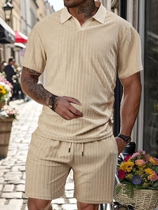 Detailed texture of beige vertical striped knit polo and drawstring shorts for men