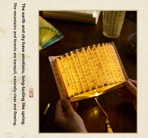 Detail of Chinese calligraphy fan book lamp with warm light and elegant tassel