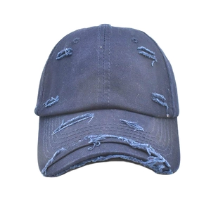 Detailed close-up of distressed navy blue cotton baseball cap with ripped edge design