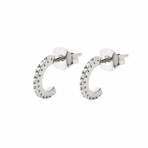 Macro view of C-shaped silver earrings featuring micro-pave white zircon and butterfly backs