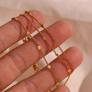Macro shot of gold-plated stainless steel chain with polished flat sequins