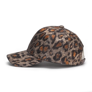 Detailed side view of leopard print baseball cap with metallic fabric and curved brim