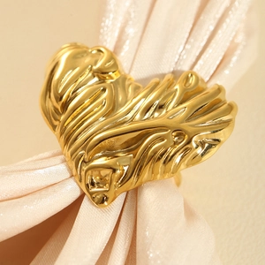 Macro detail of gold-plated irregular heart ring with unique crinkled metal texture