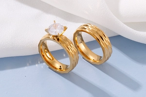 Detailed view of diamond-cut gold rings with a sparkling four-prong solitaire diamond
