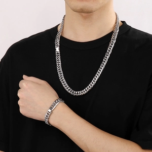 Men's 12mm silver stainless steel Cuban curb chain necklace and bracelet set on model