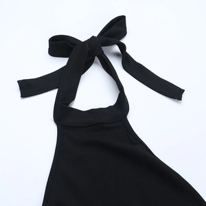 Detail of the elegant black halter top neckline featuring a delicate knit bow tie design