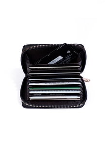 Macro shot of black leather card holder interior with 11 accordion slots and gold zipper