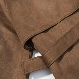 Detailed macro view of the premium brown faux suede fabric texture and waist belt stitching