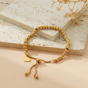 Golden stainless steel beaded bracelet with heart pendant and adjustable drawstring closure