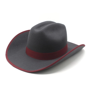 Detail of dark grey felt cowboy hat with burgundy ribbon band and matching bound edge
