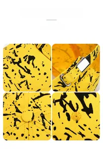 Detail of yellow cotton baseball cap showing paint splatter print and metal adjustment buckle