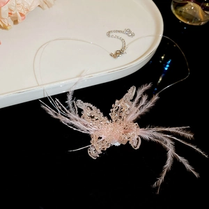 Detailed macro view of pink feather butterfly pendant with crystal beads on clear wire