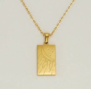 Macro shot of 18K gold plated stainless steel sun and stars tarot rectangle pendant necklace