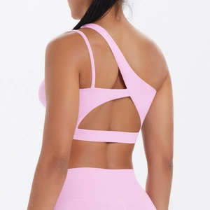 Detailed back view of pink sports bra with asymmetrical cutout and high waist leggings