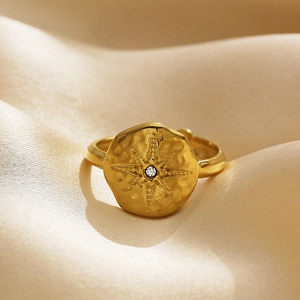 Golden stainless steel ring with hammered texture and a sparkling starburst zircon detail