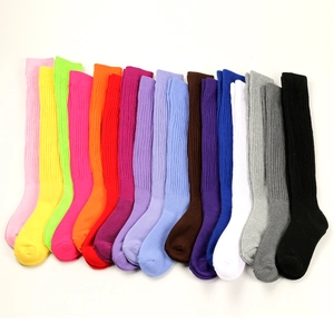 Flat lay of colorful ribbed knit slouch socks in multiple vibrant color variations
