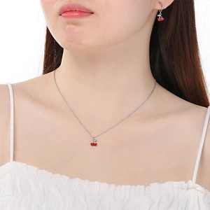 Elegant stainless steel cherry necklace and earring set with vibrant red and green enamel finish