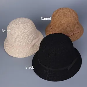 Three knitted straw bucket hats in beige, camel and black with fine ribbon decoration