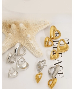 Detailed view of polished heart-shaped stainless steel stud earrings in gold and silver