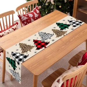Christmas table runner featuring plaid and leopard print tree patterns on wooden surface