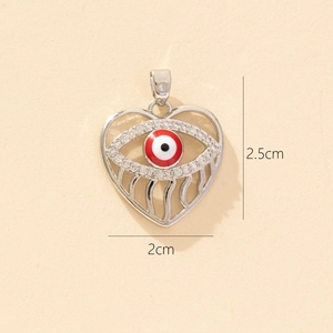 Detailed view of silver heart pendant with red evil eye and size markers 2.5cm by 2cm
