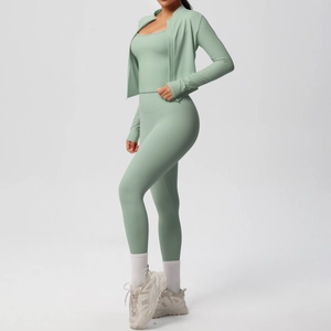 Three-piece pale green yoga set featuring a zip-up jacket, cami top and high-waist leggings
