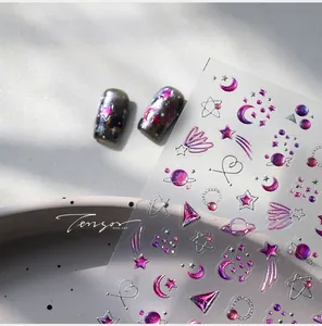 Macro detail of starry moon embossed nail stickers with pink purple laser metallic texture