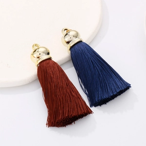 Detail of blue and brown silk tassels with gold metal caps and hanging rings