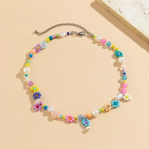 Detail of colorful beaded choker with flower patterns and silver lobster clasp