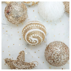 Detailed view of champagne gold sequined Christmas balls and plush starfish ornaments