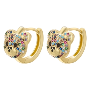 Macro shot of huggie hoop earrings with colorful zircon teddy bear stud detail