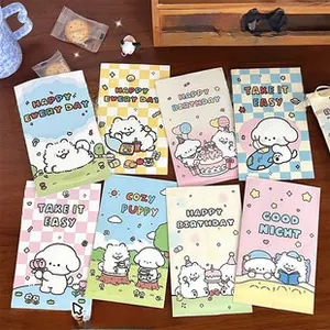 Pastel heart bubble envelopes with cute dog prints displayed on a rustic wood surface