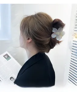 Floral acetate hair claw clip shown in a stylish updo hairstyle for a minimalist look