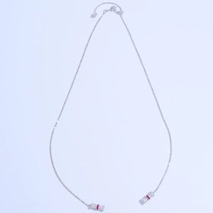 Detail of S925 sterling silver chain with white and red gemstone decorative ends