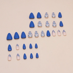 Short almond fake nails featuring royal blue gloss and floral line art on light pink base