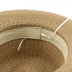 Detail of straw hat interior showing sweatband and adjustable drawstring for head size