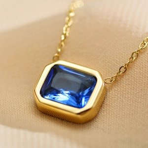 Minimalist stainless steel necklace featuring a rectangular blue zircon pendant on a gold chain